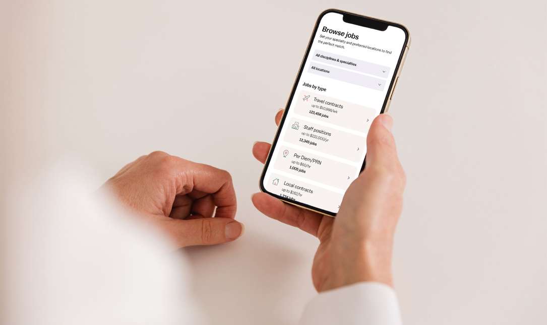 A nurse browsing Vivian jobs using a phone.