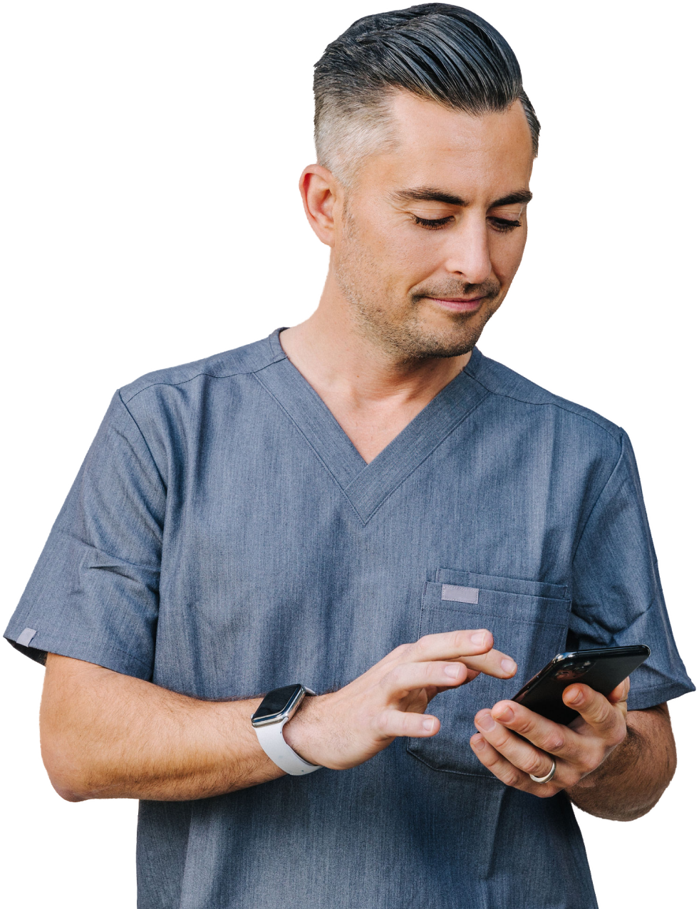 A healthcare professional in blue scrubs uses a smartphone