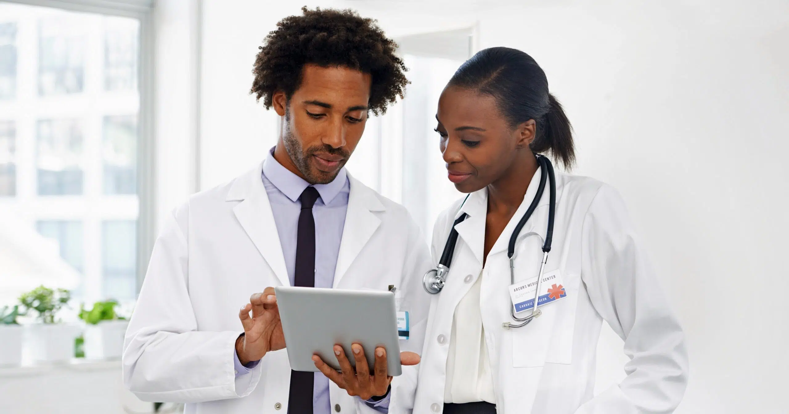 Physician assistant consulting with doctor