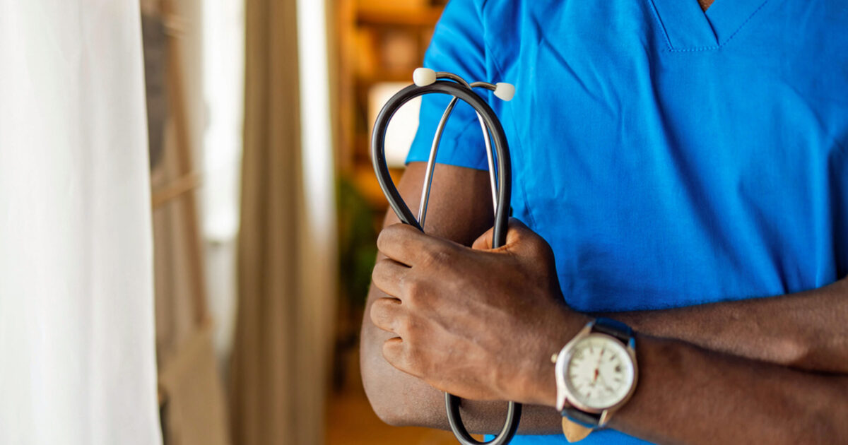 Close-up of male nurse holding stethoscope