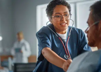 Nurse checking patient / travel RN pay