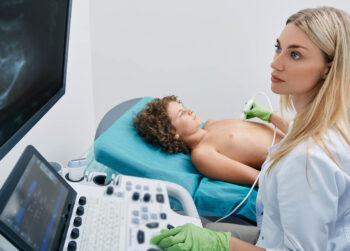 Sonography tech or ultrasound tech with young patient