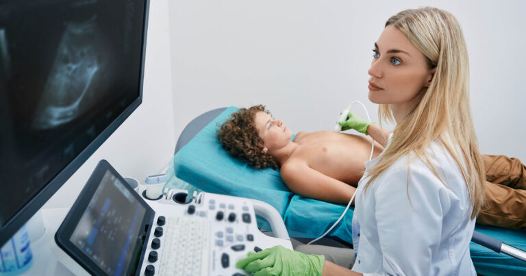 Sonography tech or ultrasound tech with young patient
