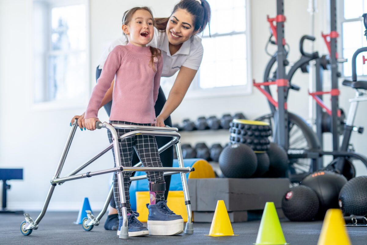 Physical or occupational therapist helping a young patient
