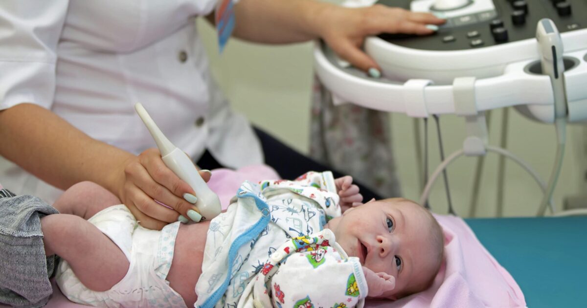 Sonographer scanning a newborn