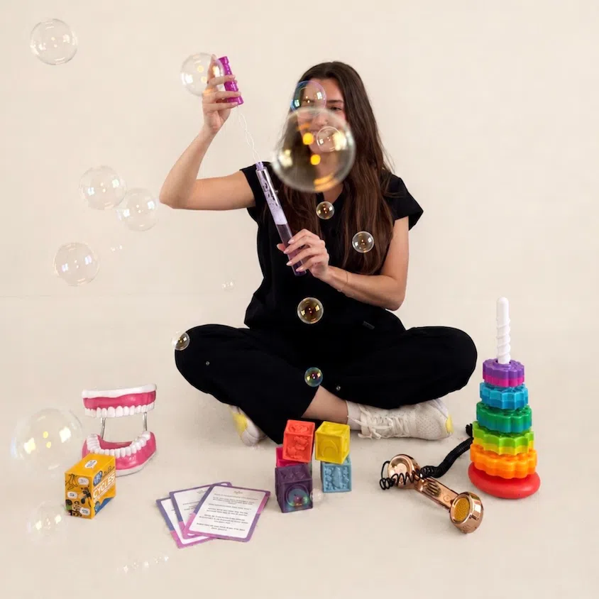 Kaitlyn, a New York SLP, using bubbles during a playful speech therapy activity