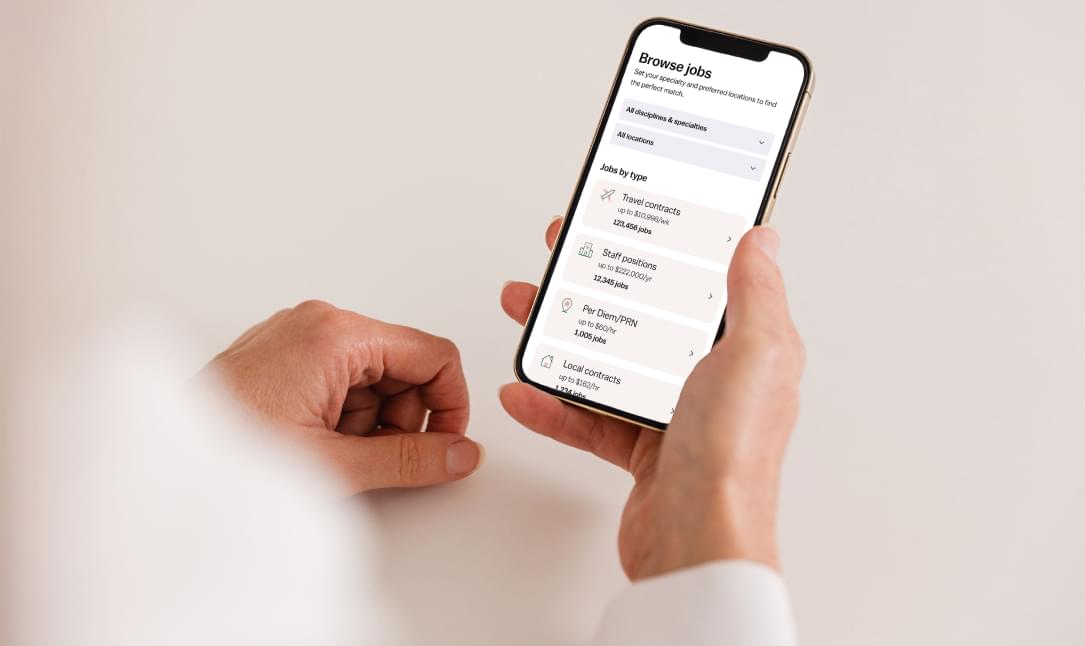 A nurse browsing Vivian jobs using a phone.